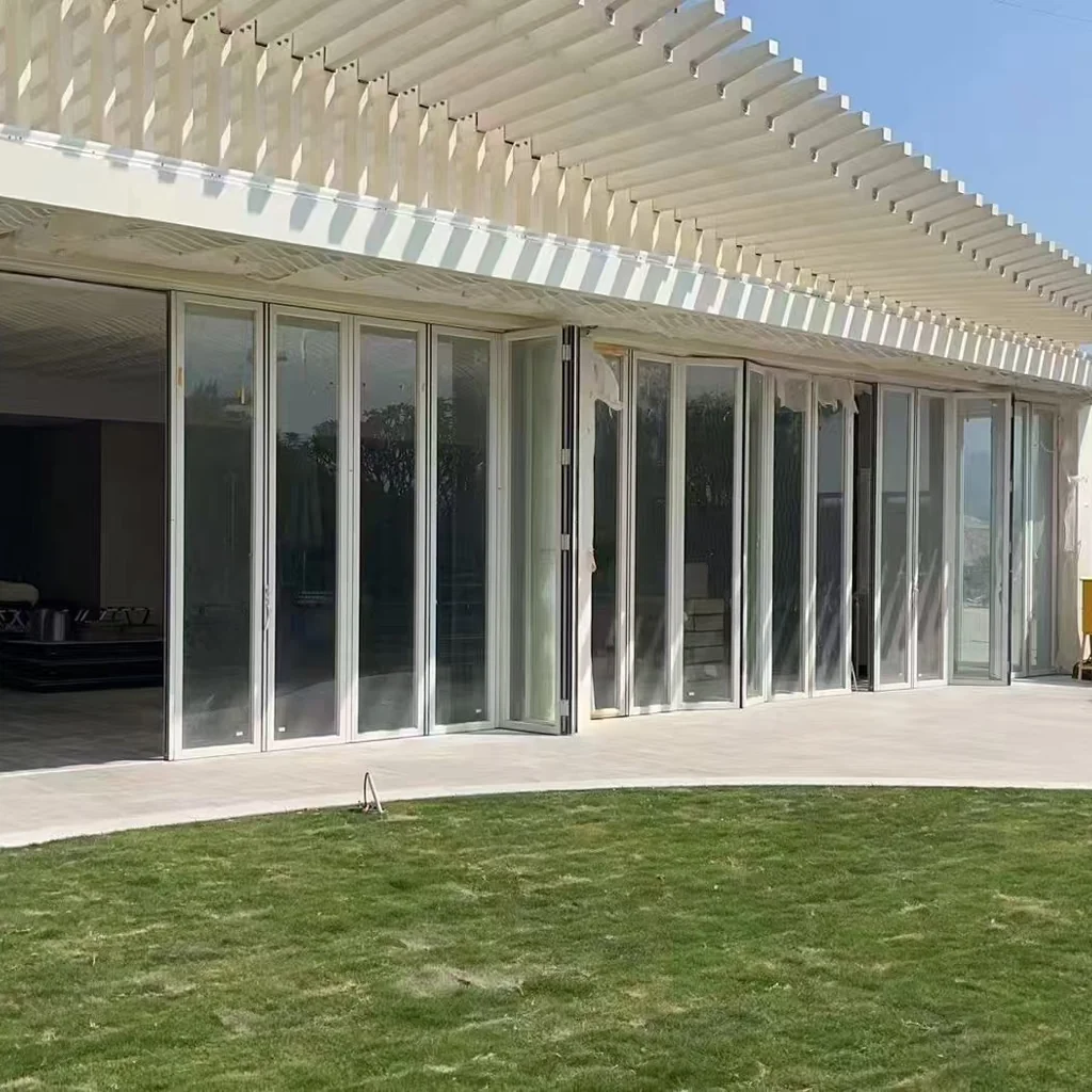 Aluminum bifold door Miami luxury villa, white exterior full opening — Starveil Build